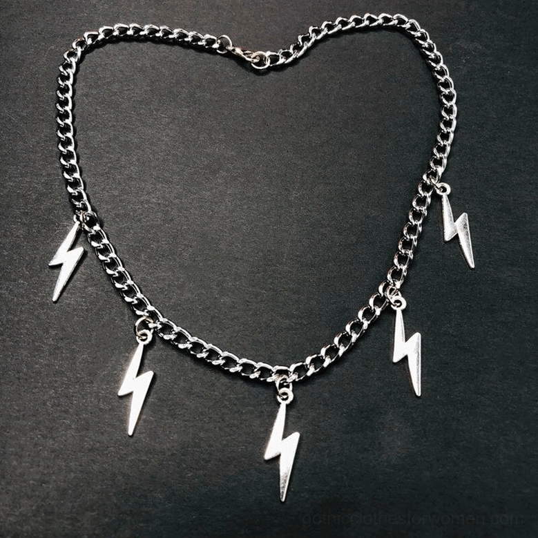 Silver lightning bolt chain necklace laid flat on dark background, showcasing full length curb chain with multiple sharp geometric lightning charms