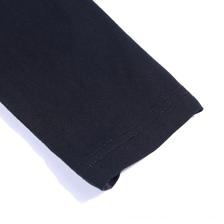 Close-up of fitted long sleeve with hem stitching on black bodycon dress showing sleeve construction and fabric drape