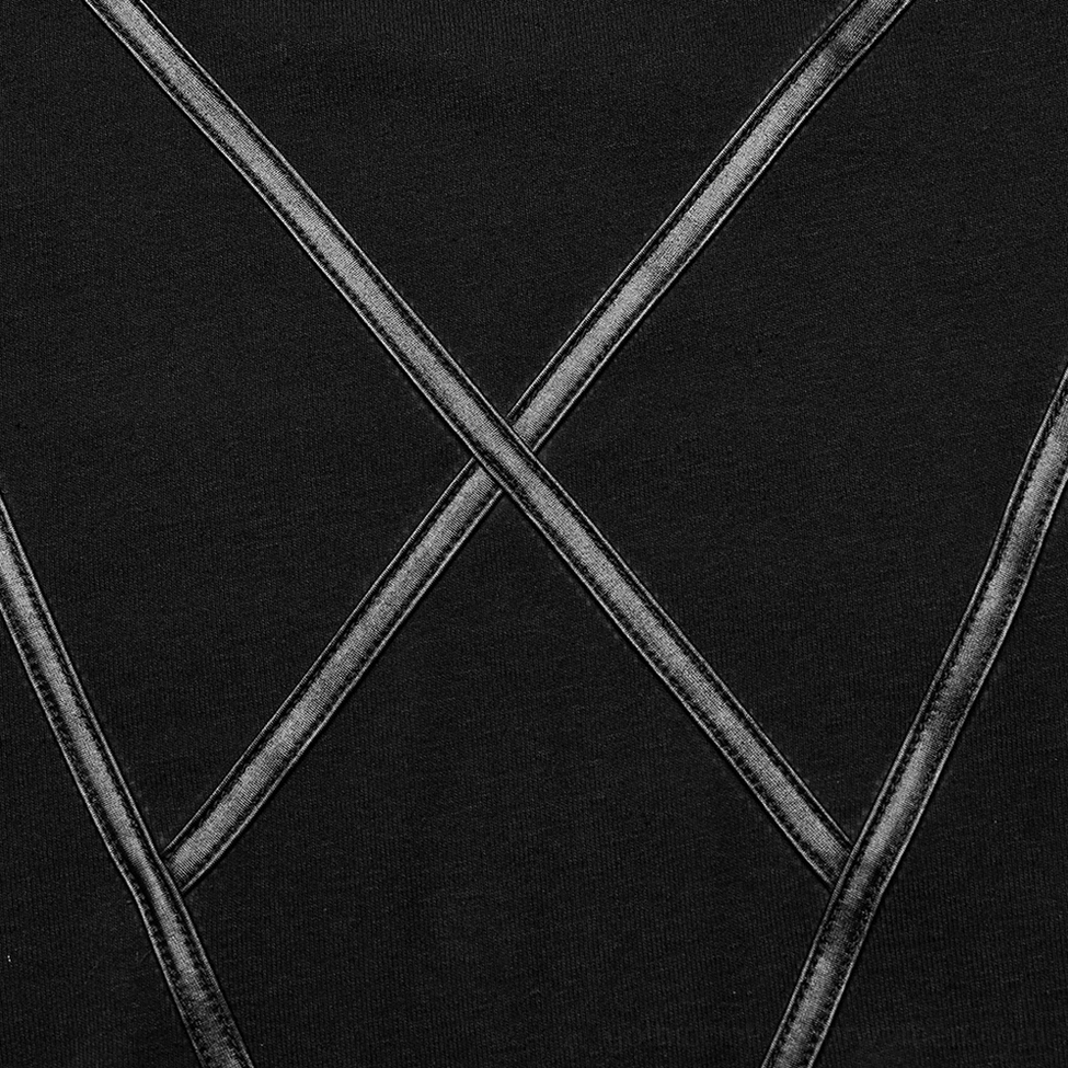 Detail shot of women's gothic knit top faux leather cross trim with metallic finish on black knit base