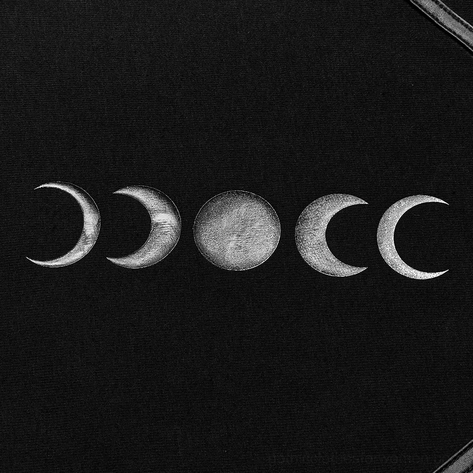 Close-up of celestial moon phase print on women's lunar gothic knit top, featuring silver-toned lunar design