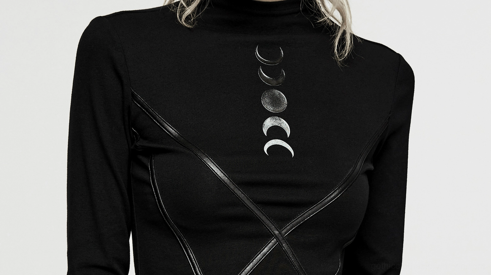 Close-up detail of women's lunar eclipse gothic knit top, showcasing gradient moon phase print and faux leather trim