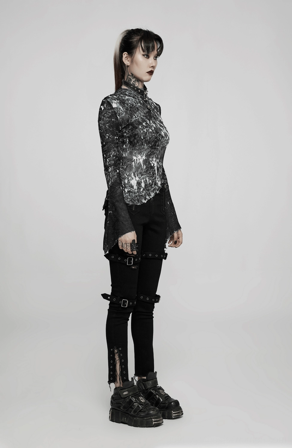 Detailed view of abstract marble pattern and construction quality of gothic fitted long-sleeve top with textured finish