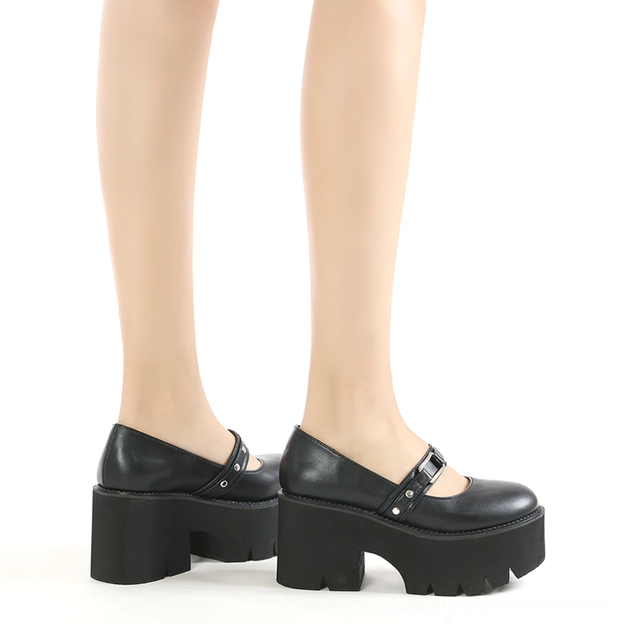Worn black Mary Jane shoes on female legs, rear three-quarter view displaying heel profile and side aesthetic