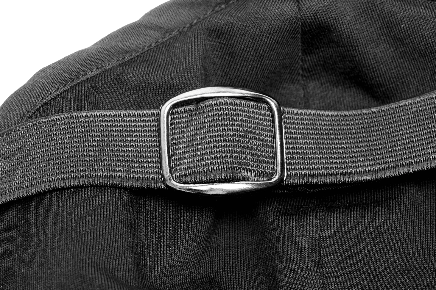 Close-up macro shot of mask strap adjustment mechanism showing elastic webbing and metal slide buckle system