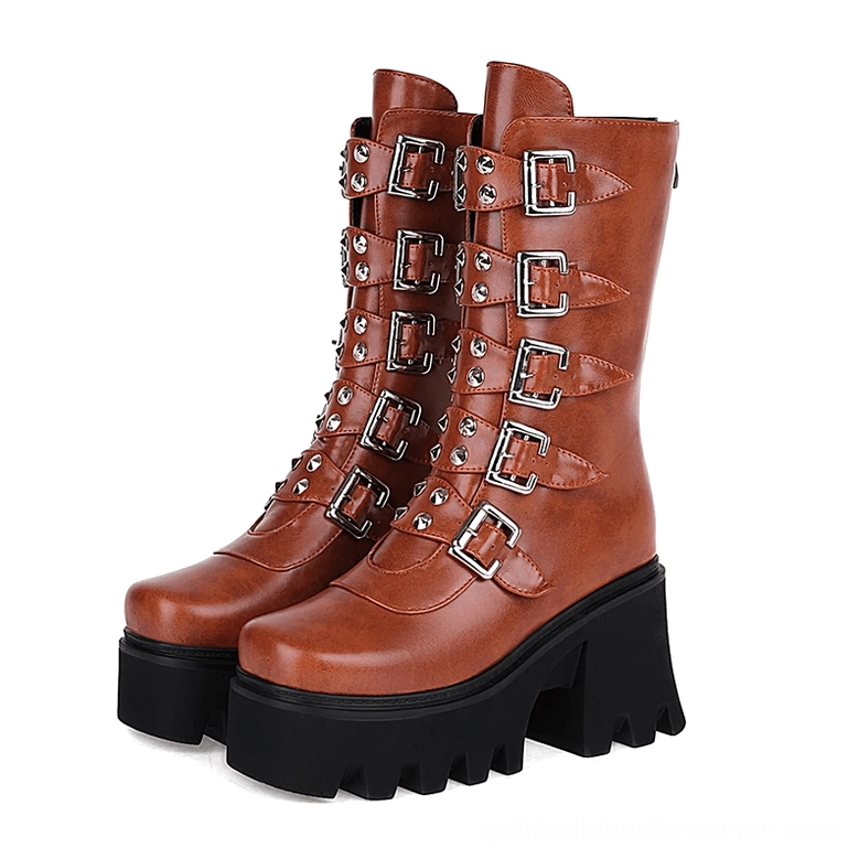 Paired cognac brown platform combat boots matching silver buckles and chunky black platform soles
