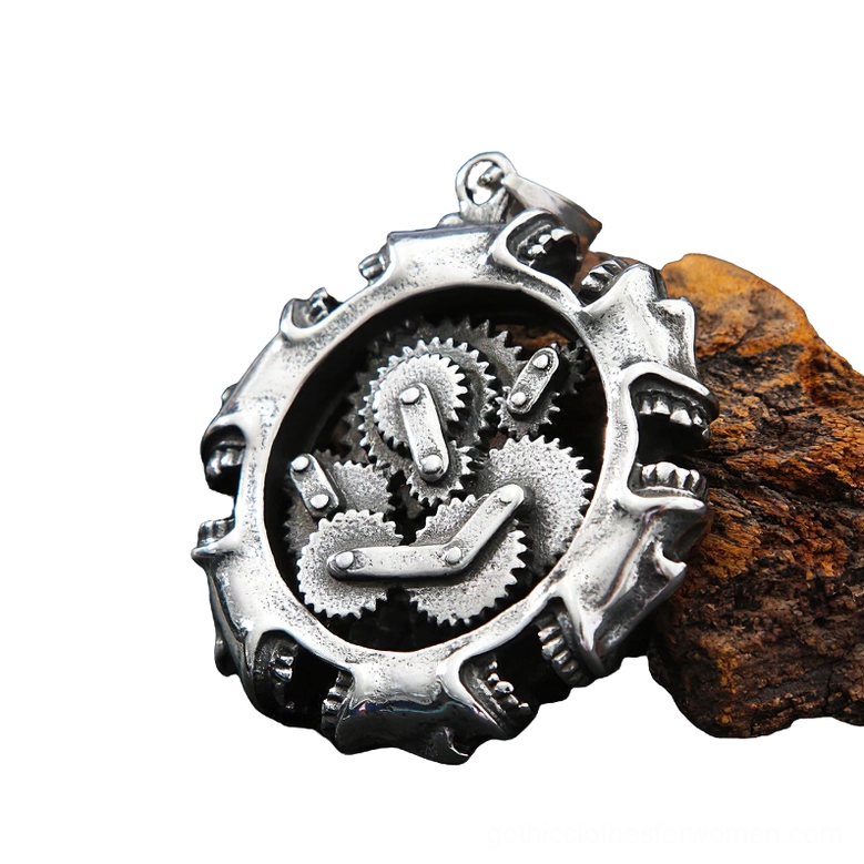 Three-quarter side view of gothic mechanical skull necklace displaying internal gear assembly on wooden block