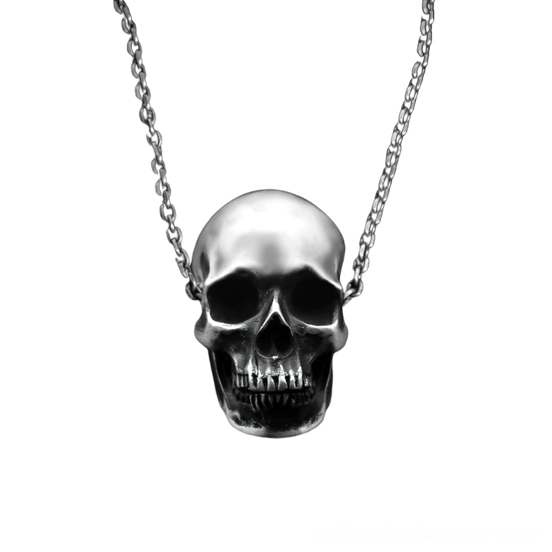 Detailed silver skull pendant with curb chain displayed on white background showing intricate teeth and cranial structure