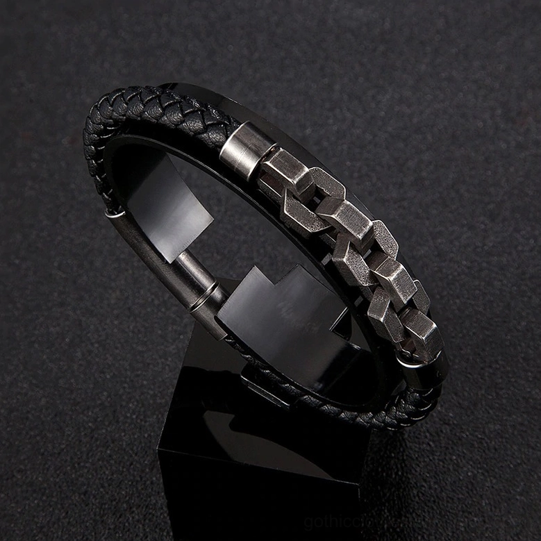 Detailed view of gunmetal chain hardware and black braided leather construction on men's gothic bracelet