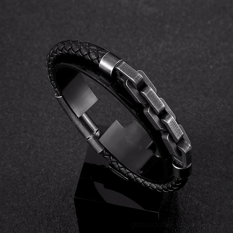 Close-up of black genuine leather braid and chunky gunmetal chain clasp on men's gothic bracelet, studio lighting