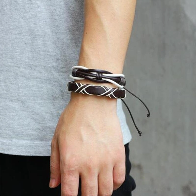 Male model wrist wearing layered brown and white twisted weave gothic leather bracelets with loose adjustable cords, side close-up view