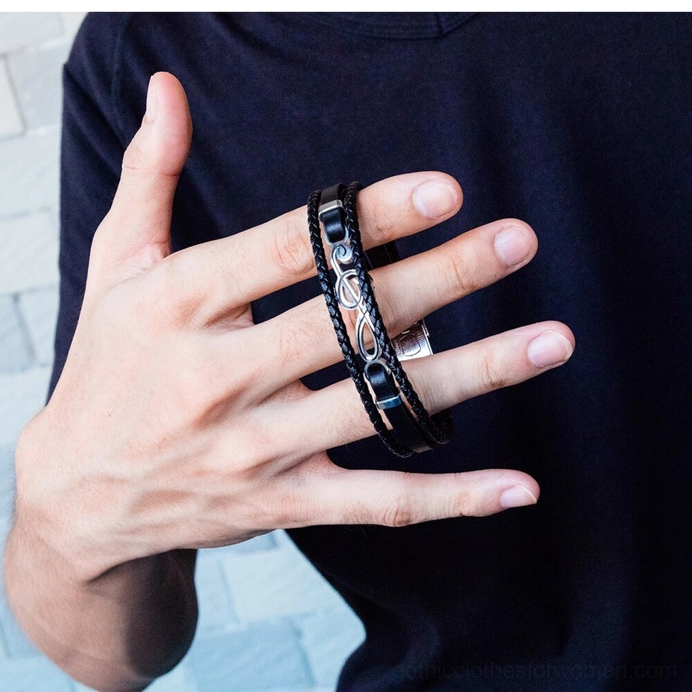 Male hand wearing double-layer treble clef gothic bracelet front close-up shot with casual dark clothing