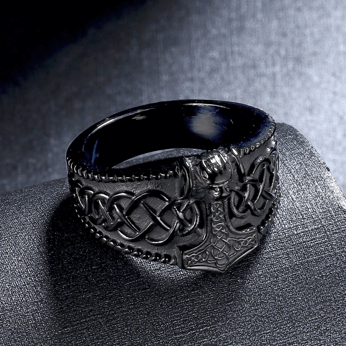 Front-facing black Mjolnir Celtic men's ring on display stand, highlighting engraved Norse hammer design