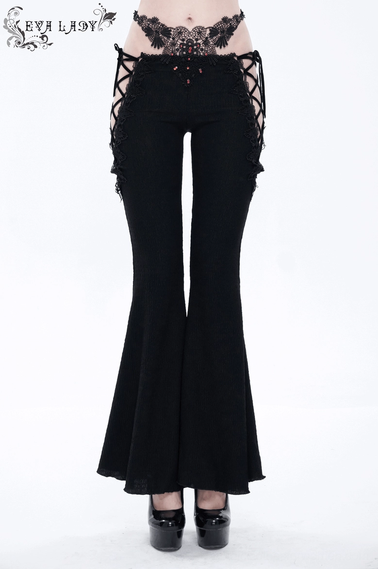 Full body front view of model wearing black lace-up flared gothic trousers with gemstone details