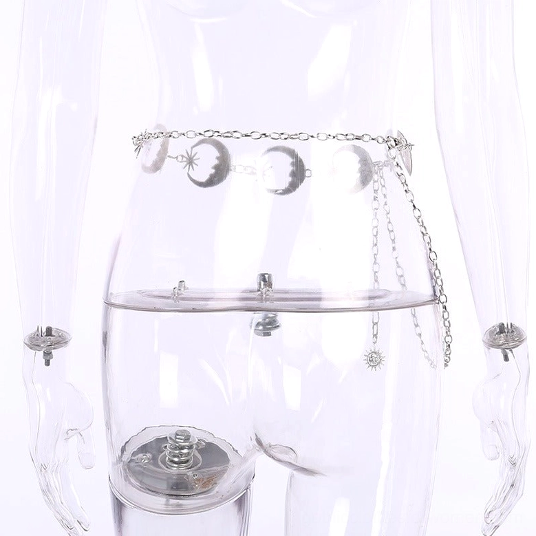 Moon and star metal chain waist belt displayed on clear plastic mannequin, front high-waist view with gothic styling