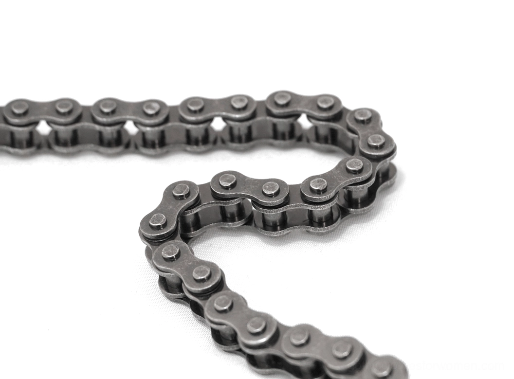 Flat lay close-up of gunmetal gray metal alloy roller bike chain style showcasing industrial motorcycle aesthetic