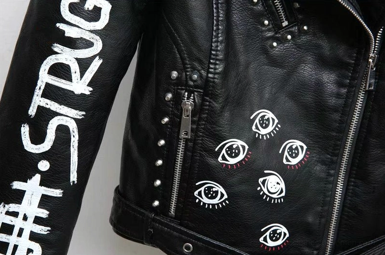 Front three-quarter view black faux leather jacket with complete visual decoration and rebellious gothic aesthetic