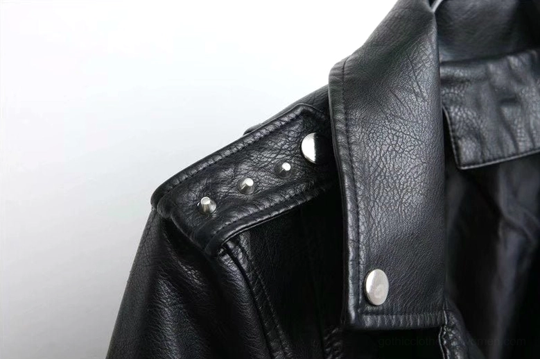 Close-up detail of black PU leather jacket zipper mechanisms decorative zippers and rivet placement on faux leather