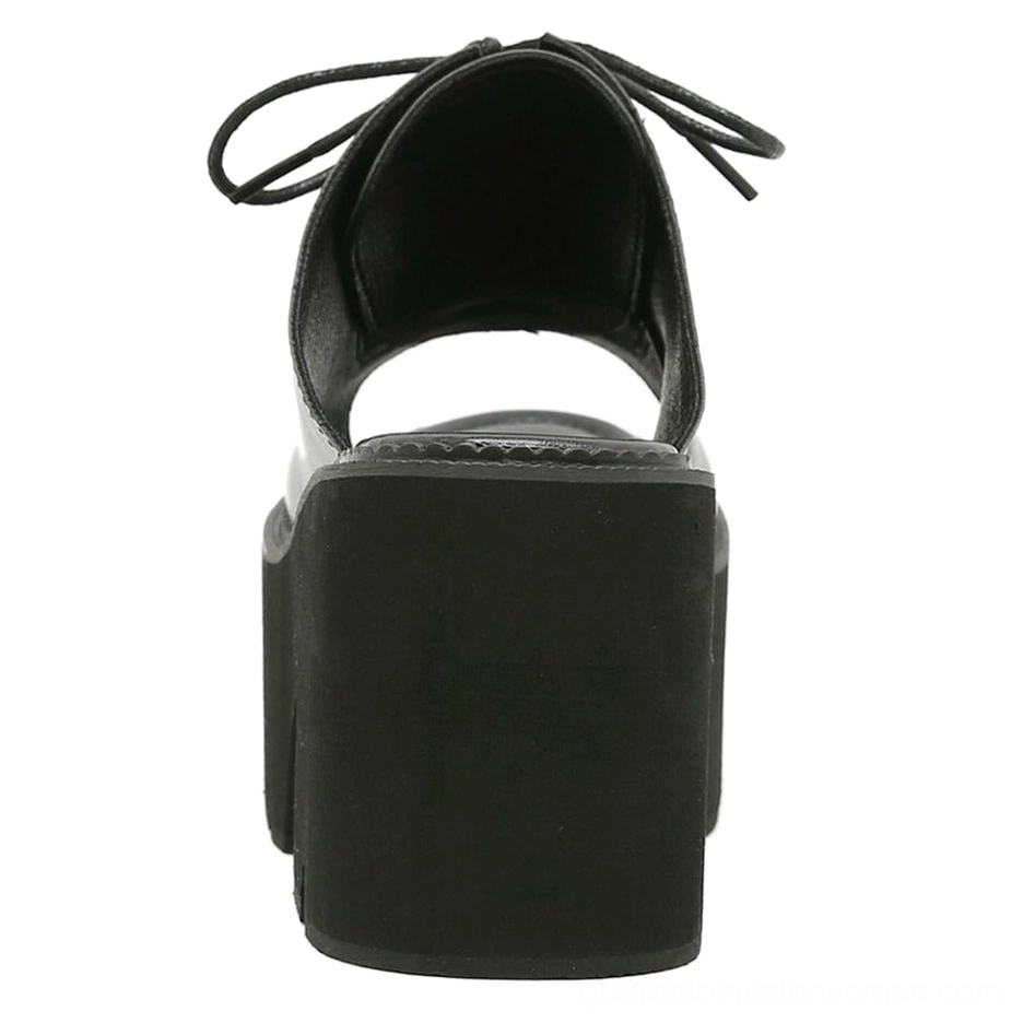 Rear view of platform mule sandal showing solid block heel and open heel collar construction