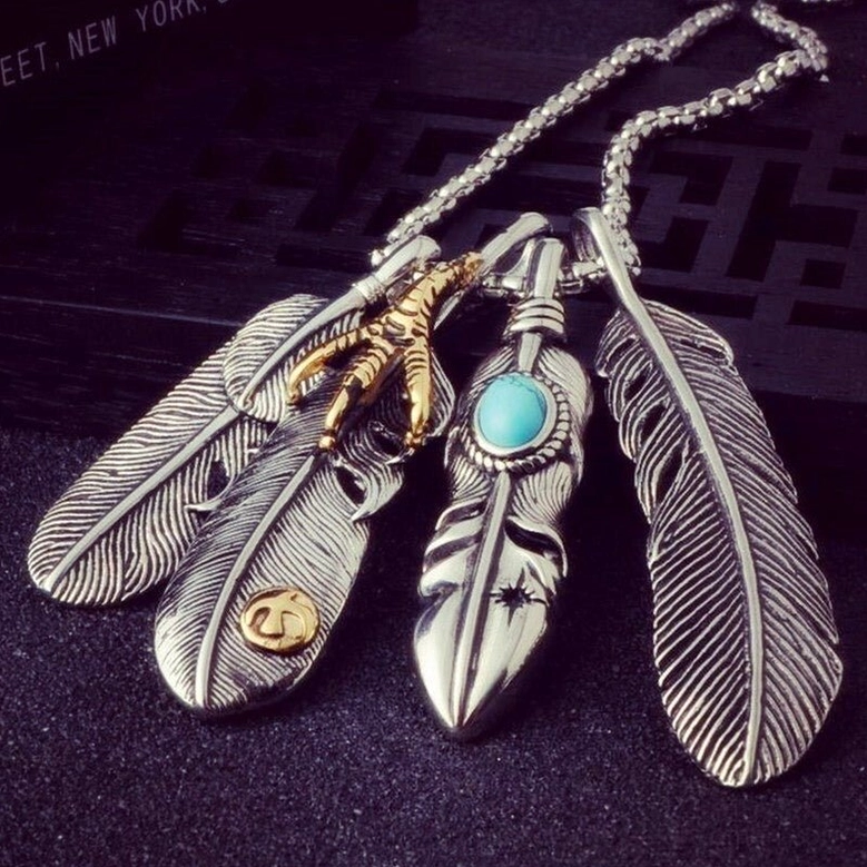Multi-feather gothic pendant necklace artistic view - four feather charms with gold eagle claw turquoise stone design