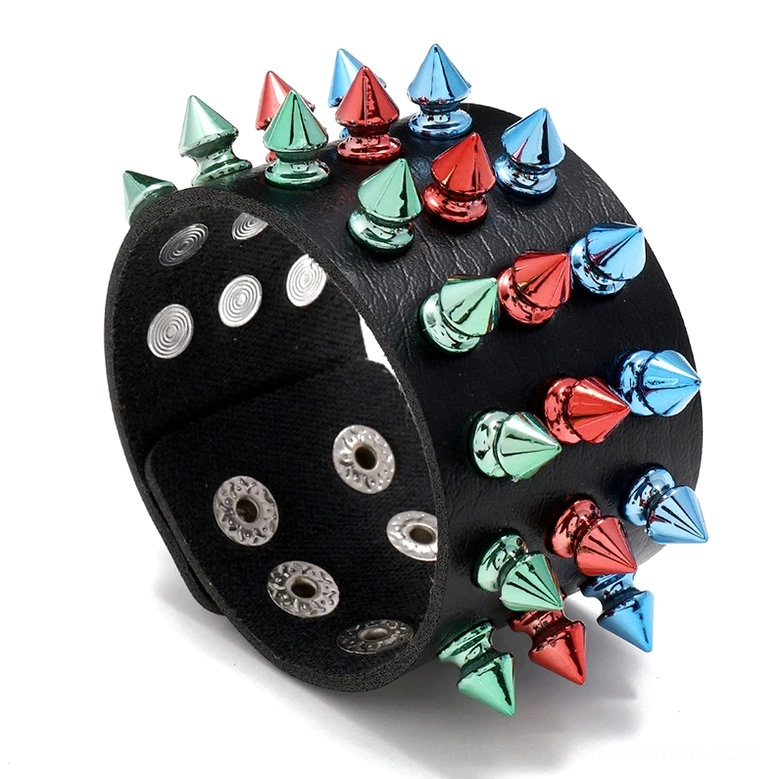 Multicolor three-row spike gothic leather cuff bracelet in black with red blue and green metal cone studs, top oblique view showing full spike arrangement