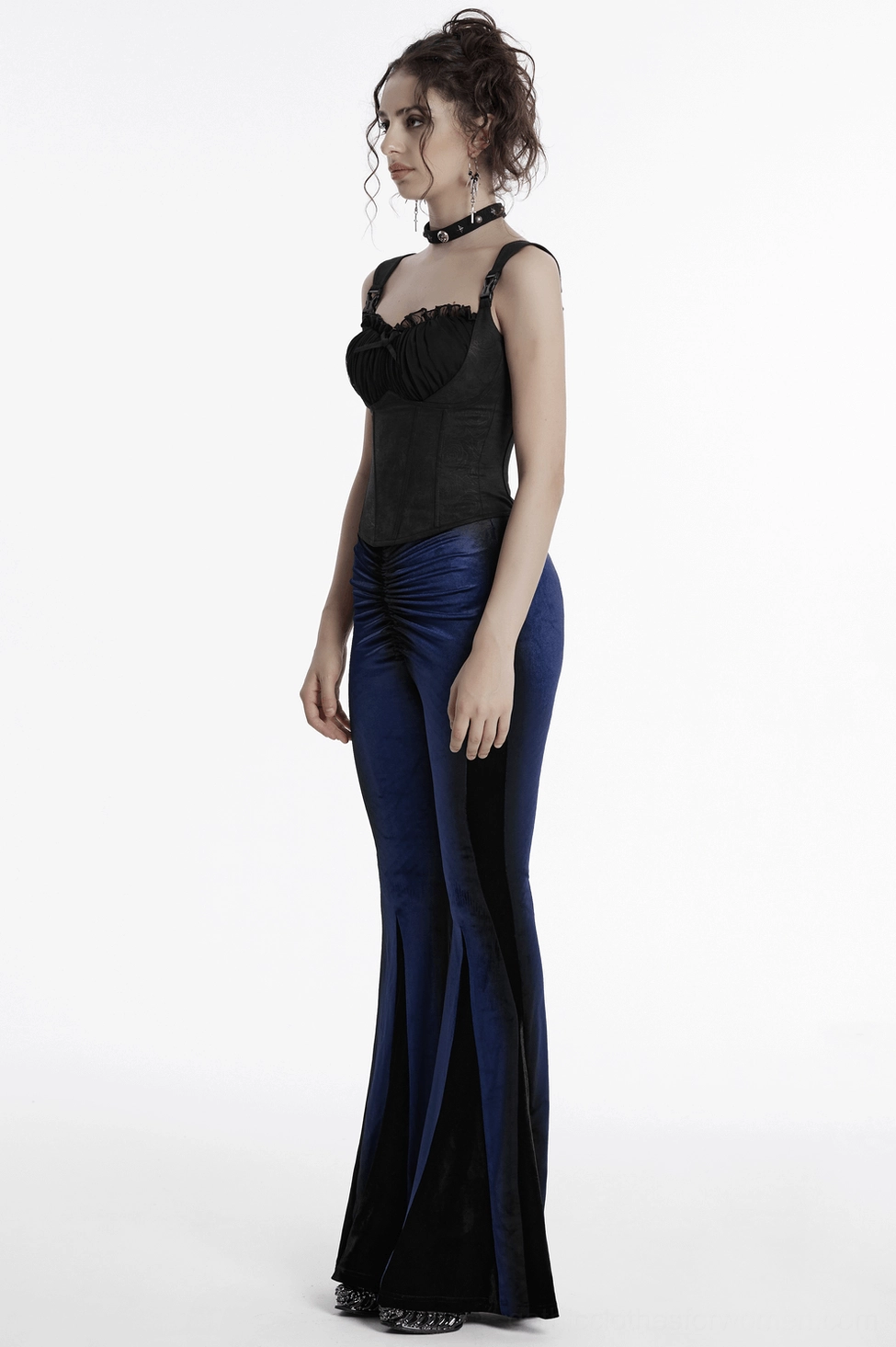 Side angle of navy velvet flare pants demonstrating black side insert panels and elegant drape