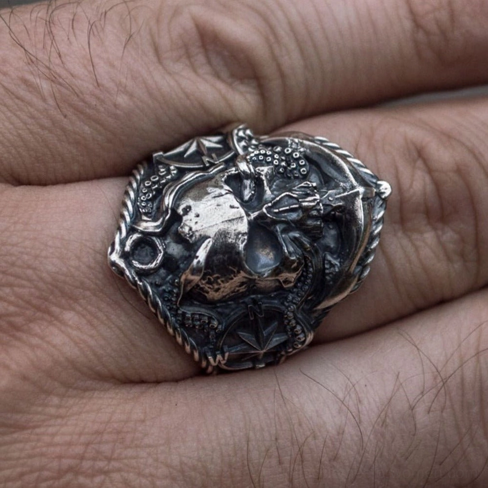 Octopus skull biker ring on male adult finger showing side profile of vintage silver metal gothic jewelry