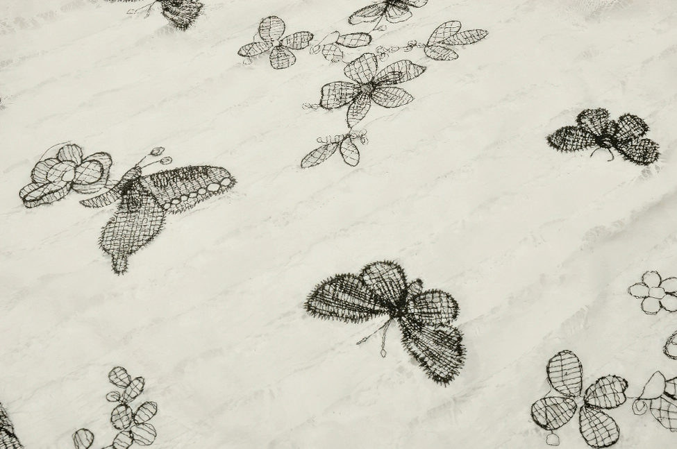 Alternative fashion gothic butterfly dress showing off-shoulder neckline with winged shoulder pads and intricate butterfly print design