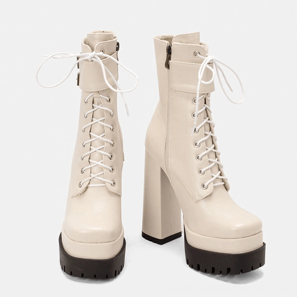 Off-white gothic platform ankle boots showing smooth leather finish and industrial buckle hardware