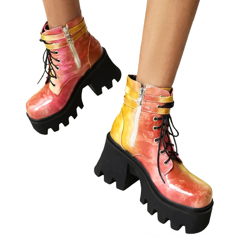 Female model wearing ombre red orange yellow gothic chunky platform boots, low side view on white background