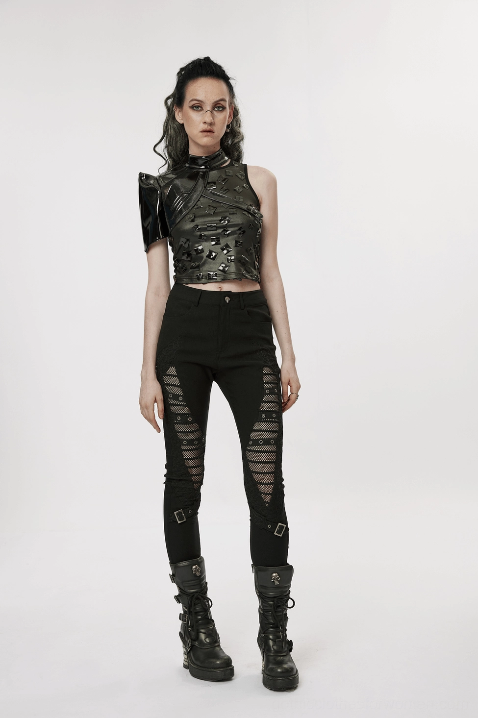 Detail shot of black patent leather one-shoulder harness strap connections and snap fastener system