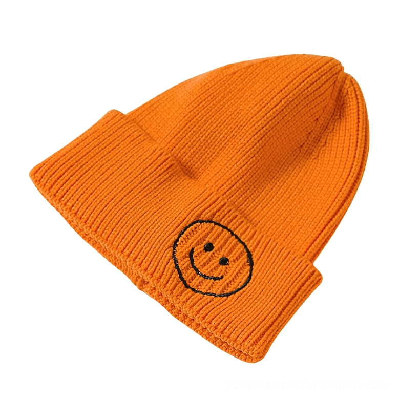 Orange smiley face knit beanie with embroidered smiley logo, dark aesthetic winter hat warm colors