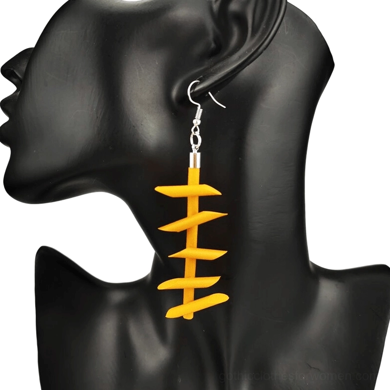 Orange twisted spike rubber dangle earrings gothic jewelry worn on black mannequin ear model close-up left side