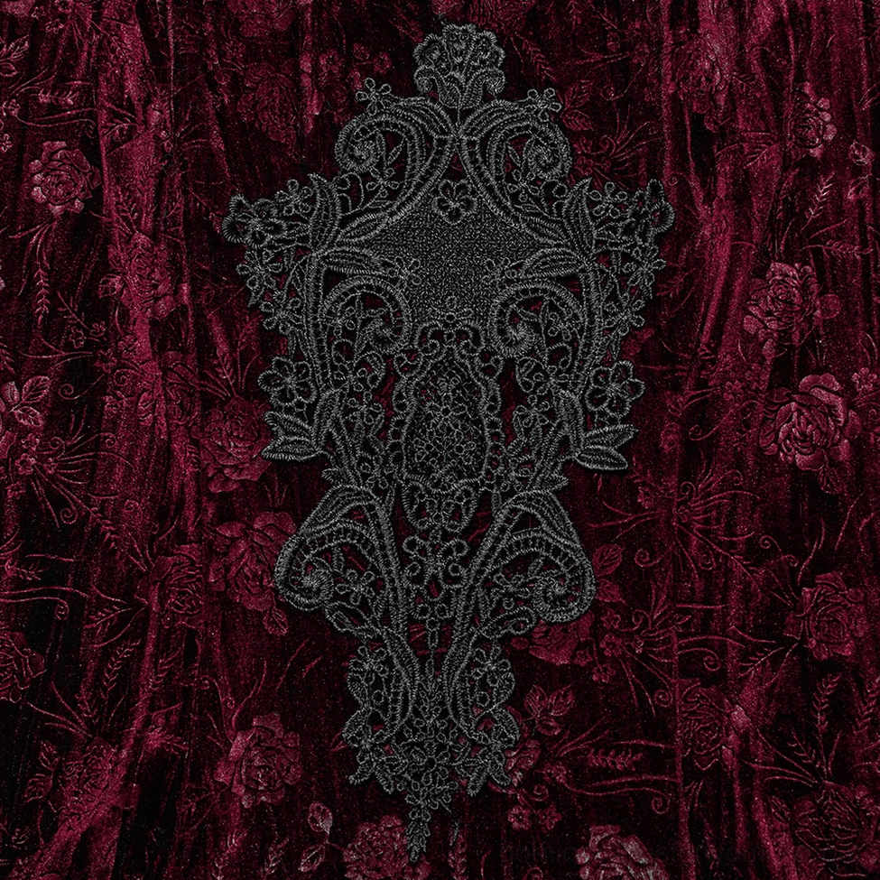 Ornate black lace embroidery appliqué detail on burgundy velvet chest area of gothic dress