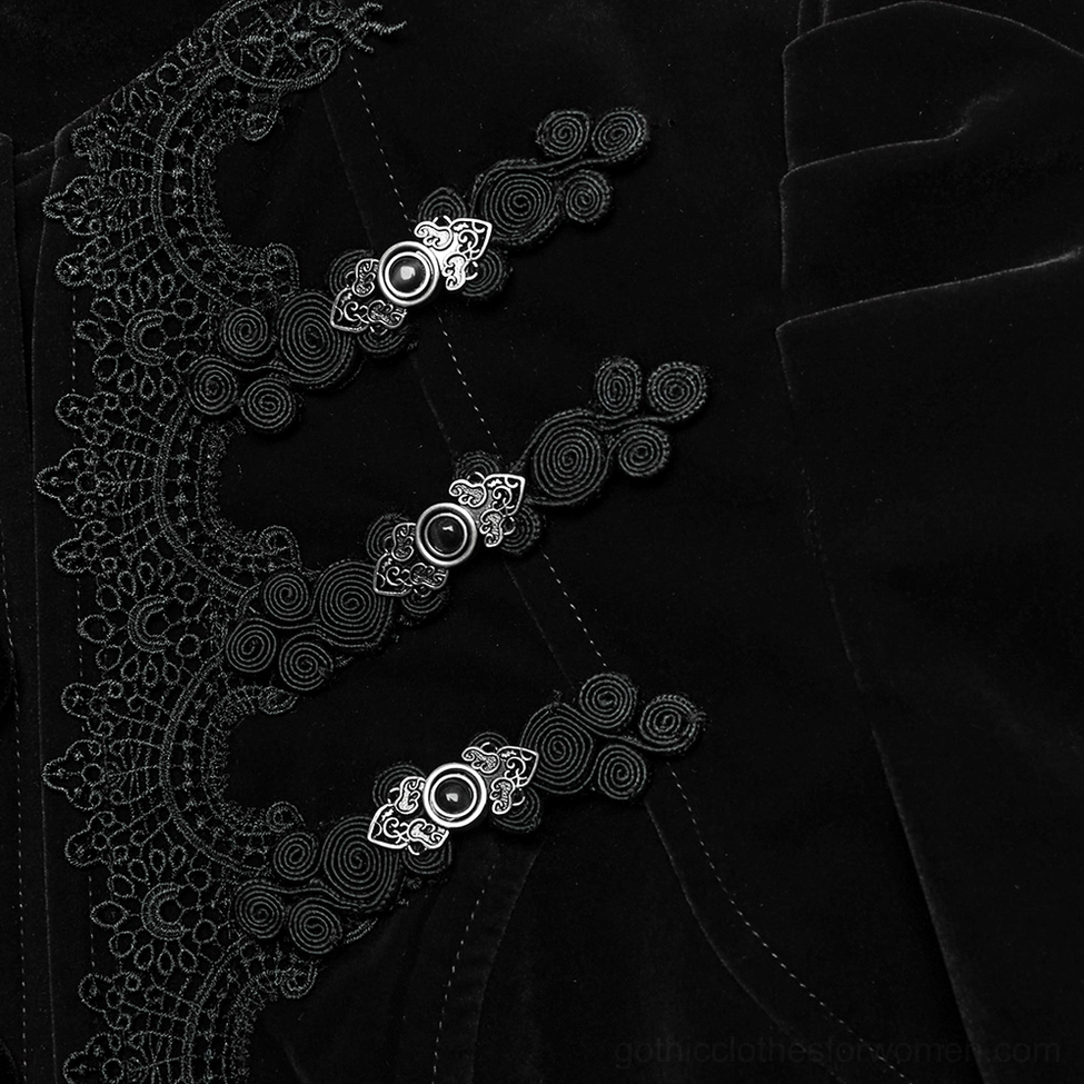 Close-up detail of ornate metal buttons and embroidered lace trim on gothic velvet jacket