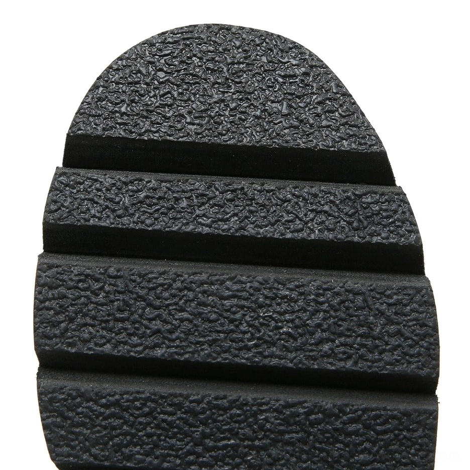 Top-down view of outsole showing deep grooved non-slip tread in black rubber material