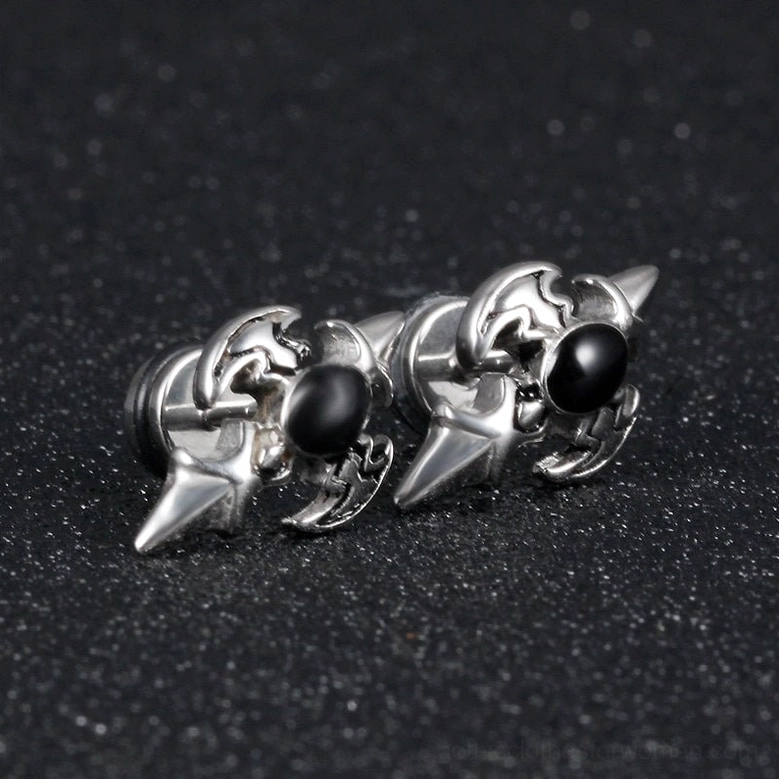 Paired silver gothic cross stud earrings with black zirconia - studio flat lay on dark matte background