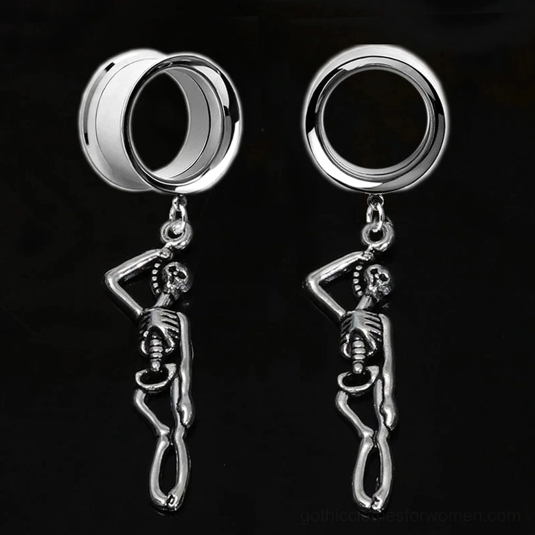 Stainless steel skull ear tunnels pair on black background – bright polished standing skeleton charms for gauged ears