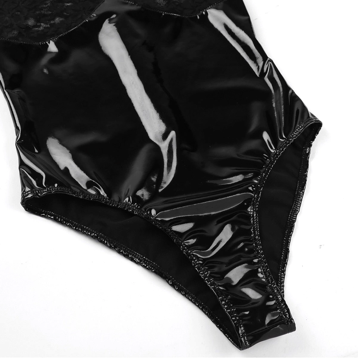 Black patent leather latex bodysuit lower half close-up, glossy finish with elastic leg trim, side flat lay detail shot