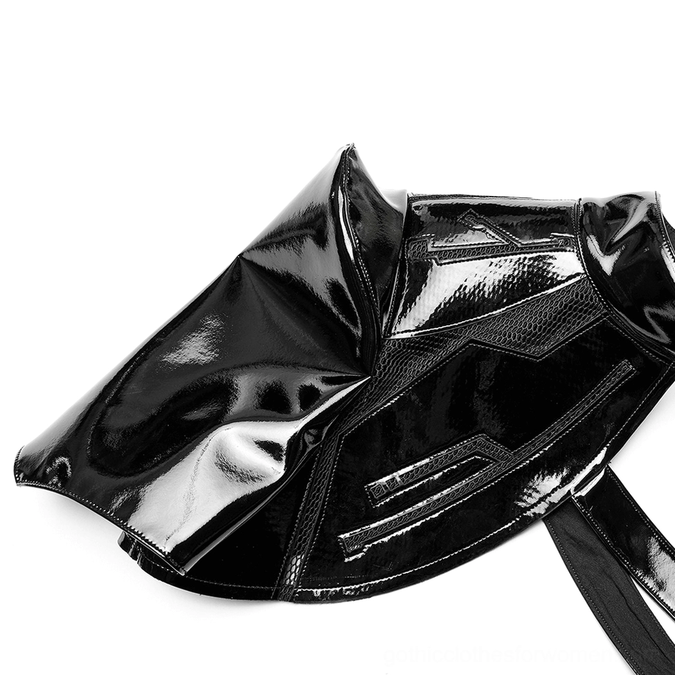 Top-down flat lay of black patent leather shoulder armor piece showing embossed geometric patterns and high-gloss finish