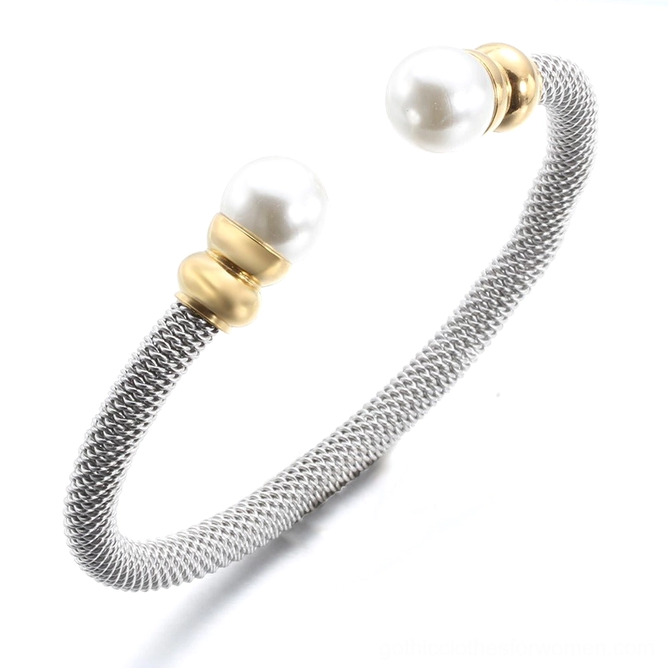 Side profile of antique silver pearl cuff bracelet showing bezel-set pearl detail and gold hardware accents