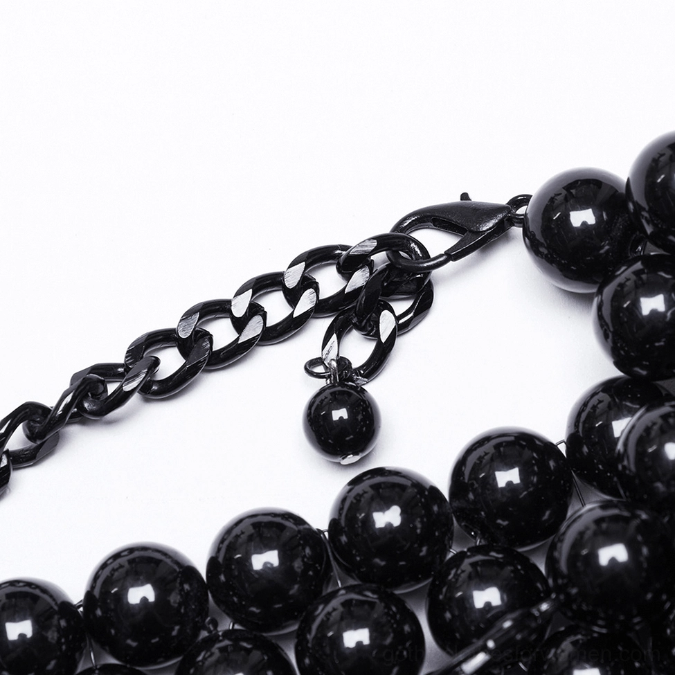 Close-up of black metal clasp fastener with pearl pendants showing adjustable back tightness mechanism