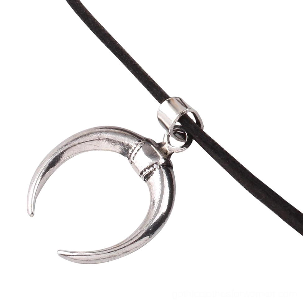 Detail view of crescent pendant connection point and velvet strap showing metal clamp hardware assembly