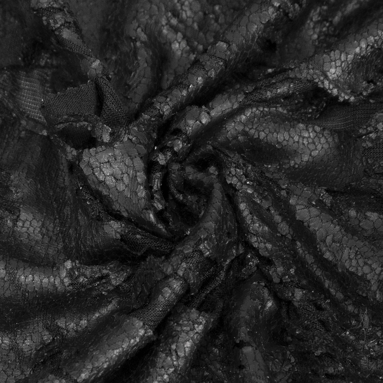 Detail view of pentagram embellishment and textile craftsmanship on black gothic hooded cape
