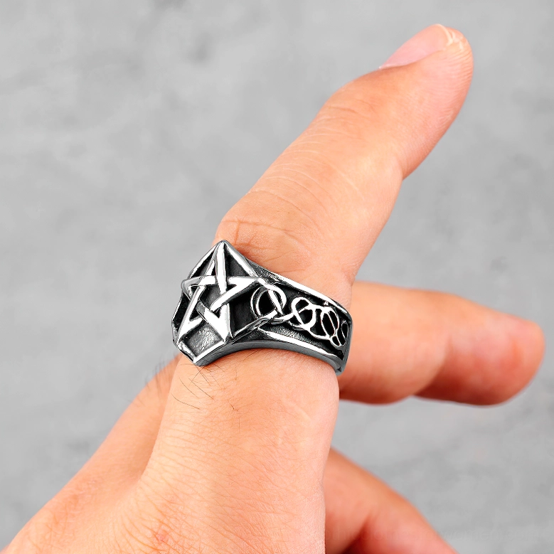 Side view of pentagram gothic ring worn on male finger, showing dimensional vintage silver-black steel profile