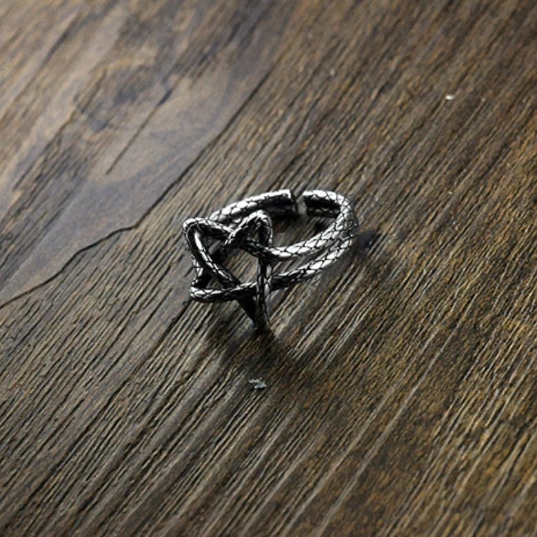 Adjustable pentagram open ring displayed on wooden surface showing woven braided texture and open band structure