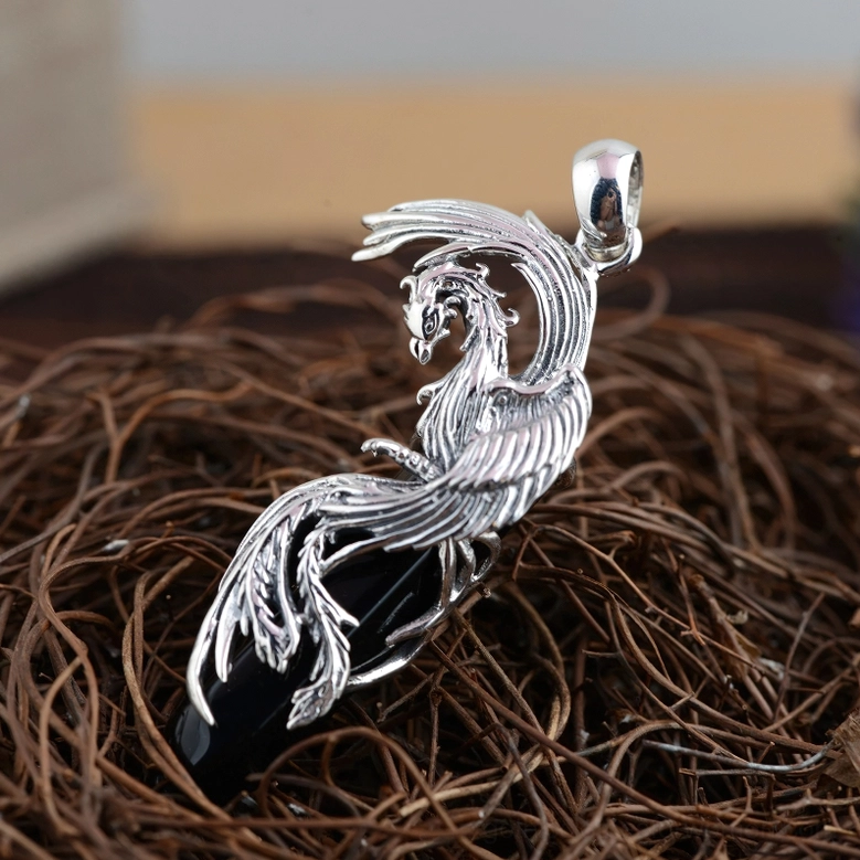 Gothic obsidian phoenix pendant right front close-up showing intricate feather details and polished black spike stone