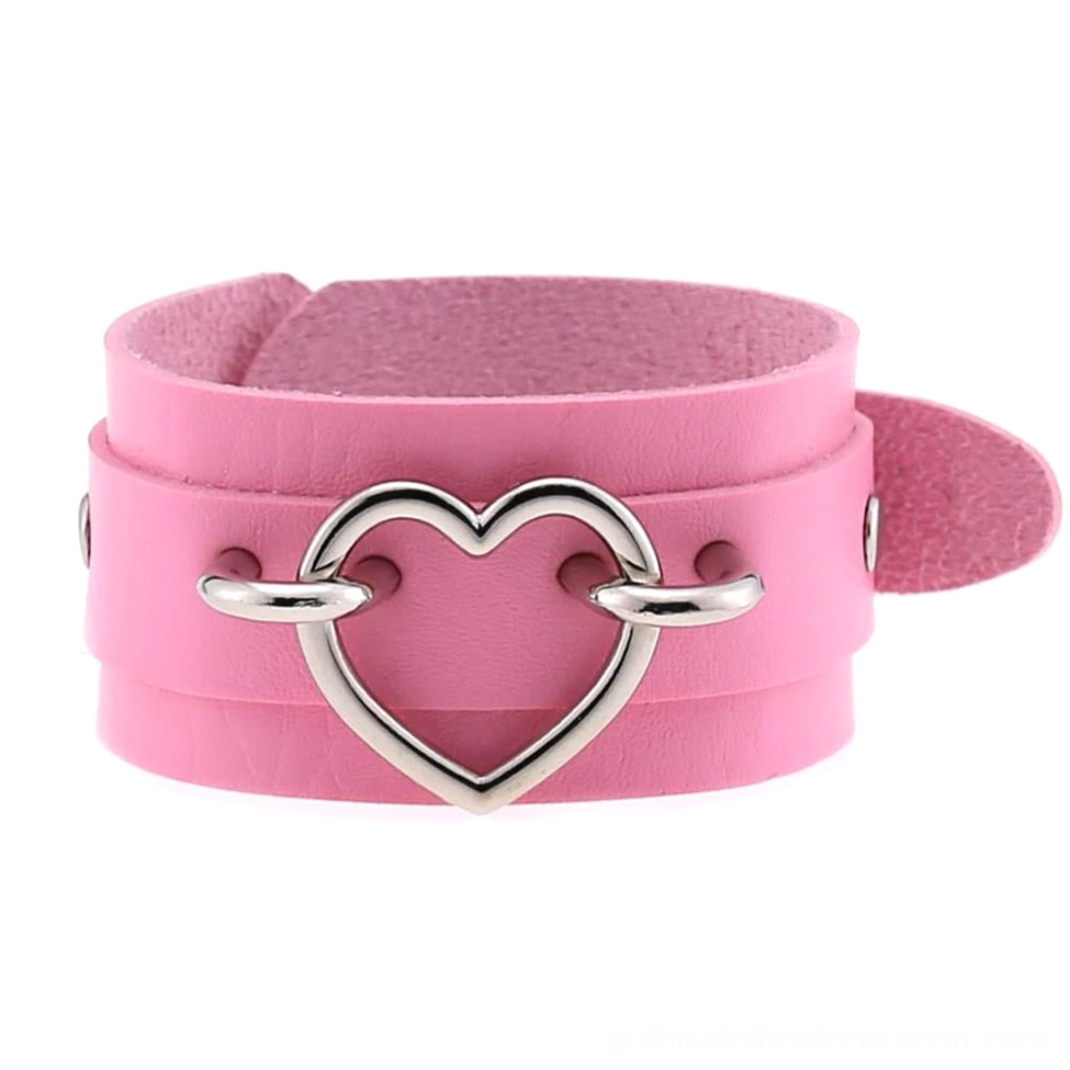 Pink leather gothic heart cuff bracelet with silver hollow heart decor, front flat lay display