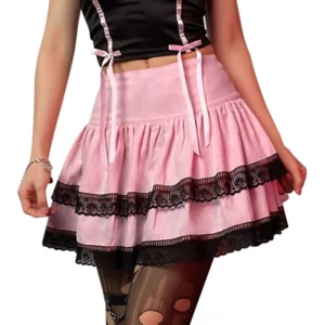 Pink tiered pleated mini skirt with black lace trim, worn by model with black crop cami top, front low angle view