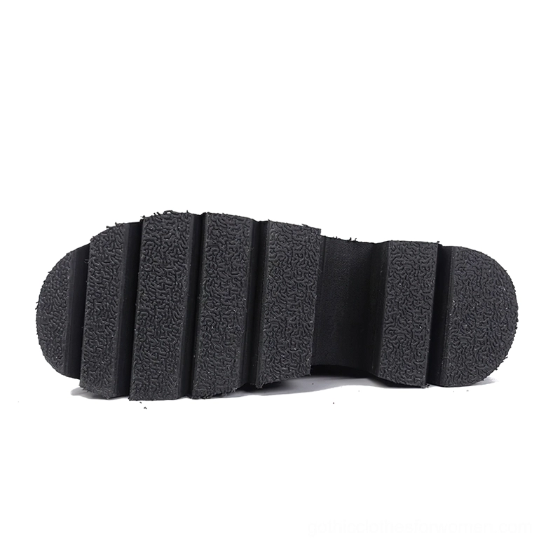 Close-up top-down view of black rubber outsole with textured lugged tread pattern for grip and traction