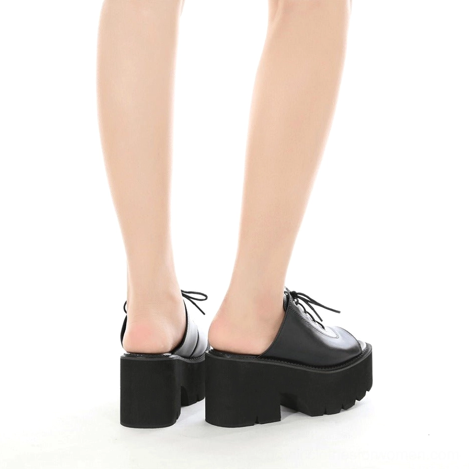 Detailed view of black platform mule sandal construction quality and material finishing